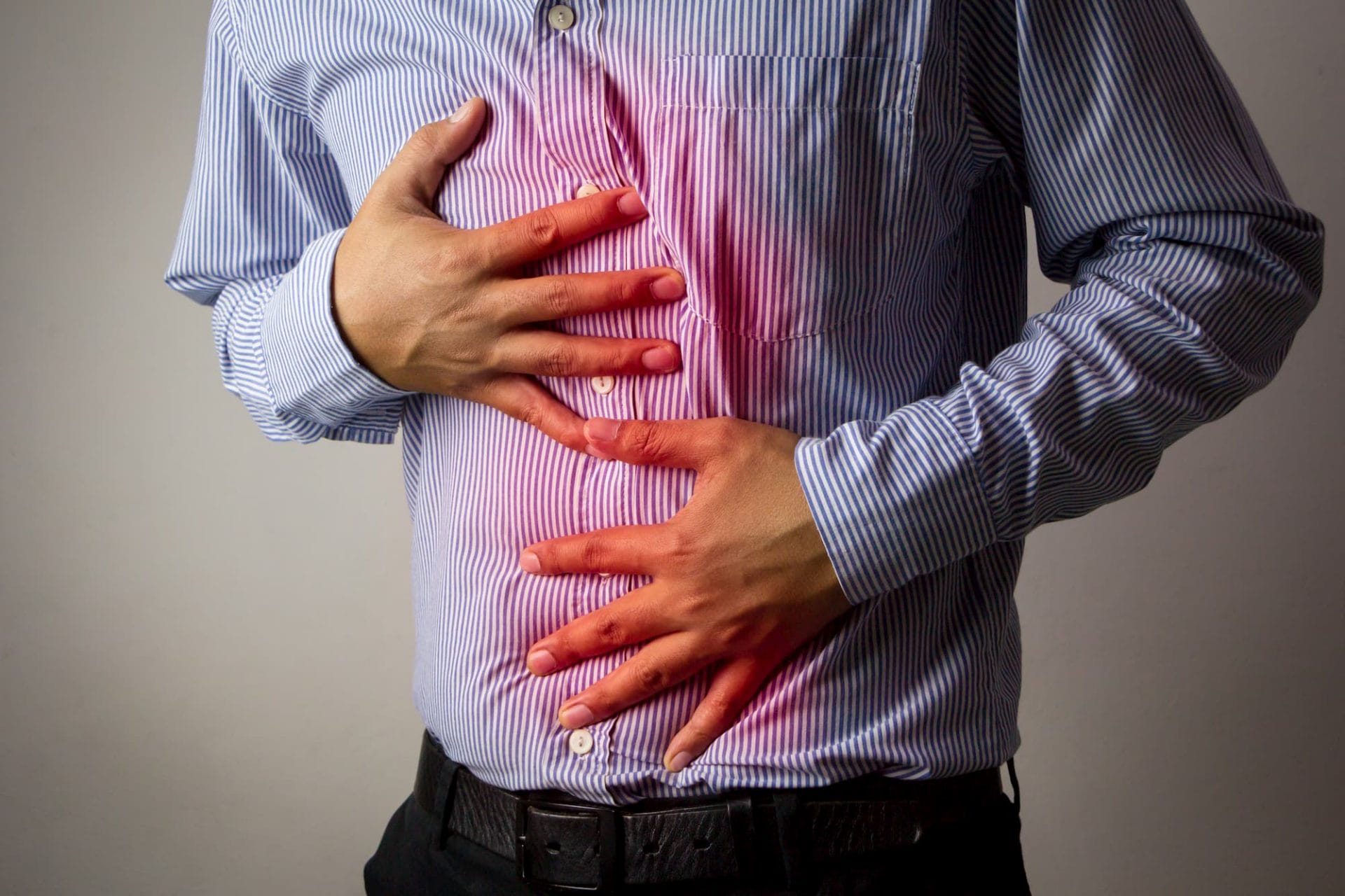 a man holding his stomach and chest in pain