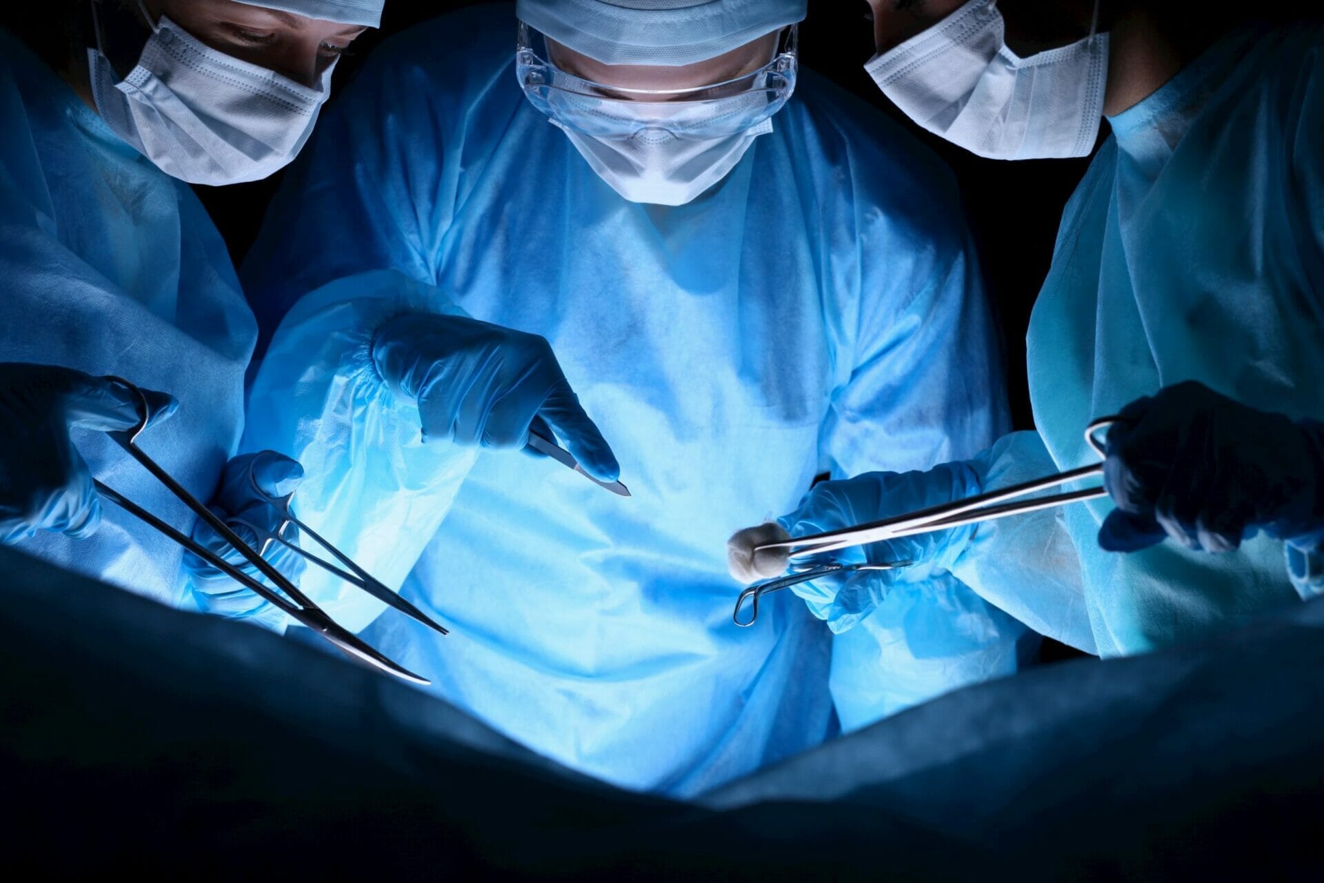 3 surgeons carrying out surgery