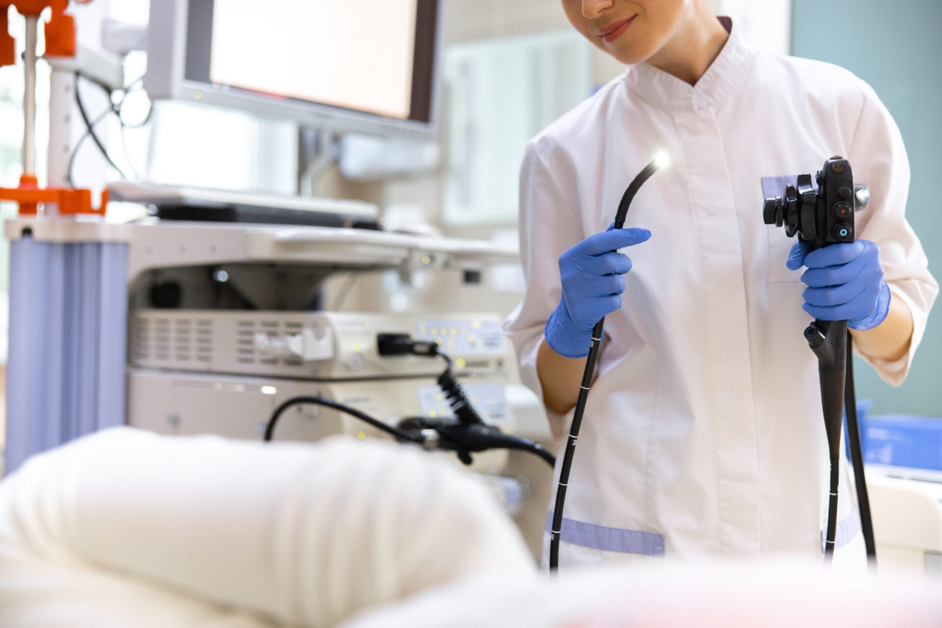 Doctor doing endoscopy examination in office stock photo Smiling female professional using digital equipment for patient treatment. Website banner